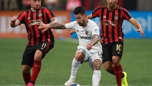 July 21, 2019 Atlanta: Atlanta United players Eric Remedi (left) and Pity Martinez double team D.C. United player Luciano Acosta in a soccer match on Sunday, July 21, 2019, in Atlanta.   Curtis Compton/ccompton@ajc.com