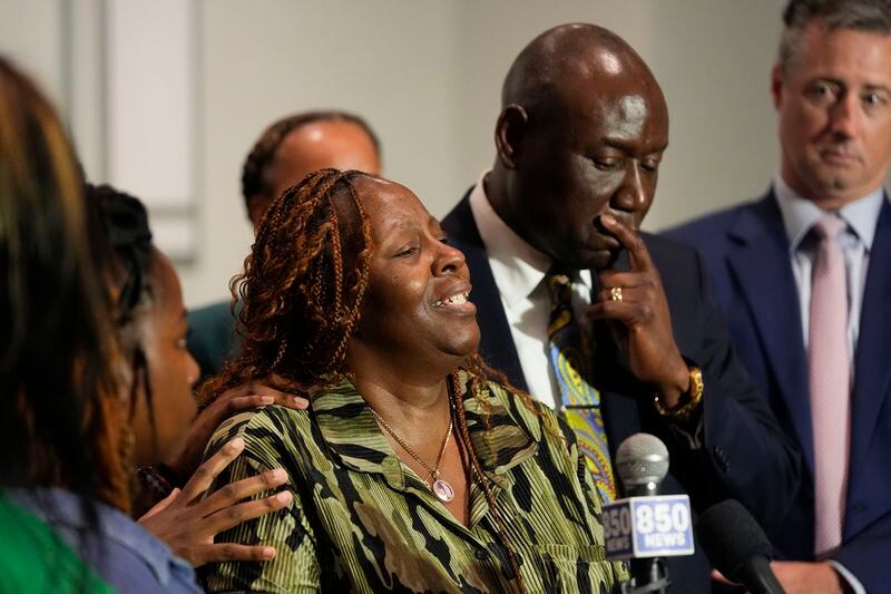 Chantemekki Fortson, mother of Roger Fortson, a U.S. Navy airman, speaks about her son during a news conference regarding his death, with Attorney Ben Crump, right, and attorney Brian Barr, far right. Thursday, May 9, 2024, in Ft. Walton Beach, Fla. Fortson was shot and killed by police in his apartment on May 3, 2024. (AP Photo/Gerald Herbert)