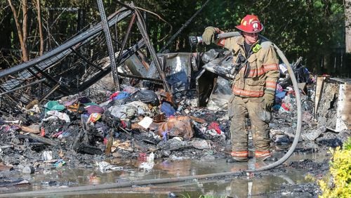 The amount of stuff in a house on Panhandle Road in Hampton made it difficult for firefighters “to put out all the hot spots,” officials said. JOHN SPINK / JSPINK@AJC.COM
