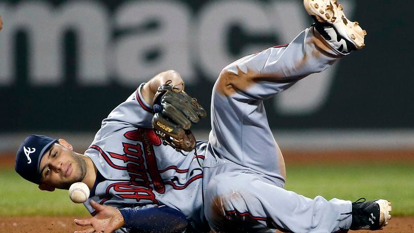 Atlanta Braves second baseman Tommy La Stella bobbles an infield hit by Boston Red Sox's Dustin Pedroia during the eighth inning of a baseball game at Fenway Park, Thursday, May 29, 2014, in Boston. (AP Photo/Winslow Townson)