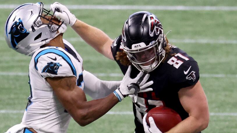 Falcons tight end Hayden Hurst (81) stiff-arms Carolina Panthers safety Jeremy Chinn (21) after a catch in the second half Saturday, Oct. 11, 2020, at Mercedes-Benz Stadium in Atlanta. (Jason Getz/For the AJC)