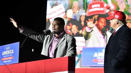 In this photo from March 26, 2022, Republican Senate hopeful Herschel Walker speaks as former President Donald Trump looks during a rally for Georgia GOP candidates in Commerce. (Hyosub Shin/The Atlanta Journal-Constitution/TNS)