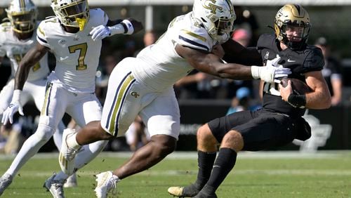 Central Florida quarterback John Rhys Plumlee (10) is sacked by Georgia Tech defensive lineman Keion White, second from right, during the first half of an NCAA college football game, Saturday, Sept. 24, 2022, in Orlando, Fla. (AP Photo/Phelan M. Ebenhack)