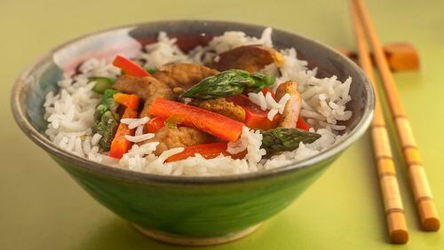 Asparagus, red bell pepper and green onions join strips of pork in this quick stir-fry. (Bill Hogan/Chicago Tribune/TNS)