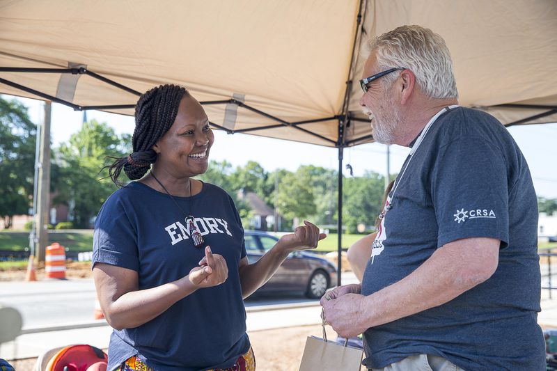 6/15/2019 -- Clarkston, Georgia -- Doris Mukangu, founder of the Amani Women's Center, speaks with a patron during a World Refugee Day celebration at Refuge Coffee Company in Clarkston, Saturday, June 15, 2019. Amani Women's Center is a organization that empowers refugee women with tools that allows them to contribute to their environment. (Alyssa Pointer/alyssa.pointer@ajc.com)