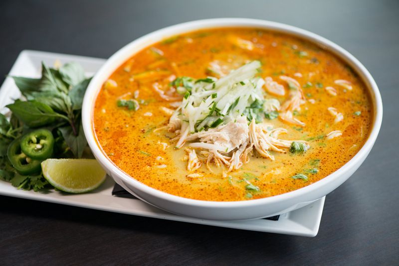  CO Curry Laksa with shrimp, shredded chicken, bun rice noodles, shredded cucumber, thai basil, baby bok choy, served in spicy coconut broth. Photo credit- Mia Yakel.