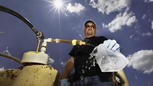 Dan Day, a water lab technician with the city of Dayton, Ohio, takes a sample from one of 200 monitoring wells used to check on the quality of water in the Great Miami Buried Valley Aquifer and test for any contaminants on a regular basis. CHRIS STEWART / STAFF