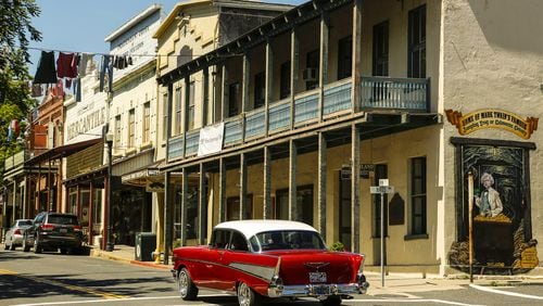 A vintage Chevrolet cruises down Main Street in Angels Camp, Calif., past the former Angels Hotel building where Mark Twain first heard the story about the famous jumping frog, on May 2, 2017. (Mark Boster/Los Angeles Times/TNS)