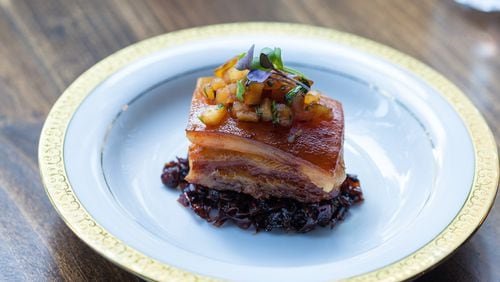 A succulent slab of pork belly, served in a nest of tart, balsamic-glazed cabbage, at the Consulate. (Contributed)