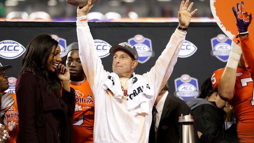 In what has become something of a routine for Dabo Swinney, the Clemson head coach raises the ACC Championship trophy after drubbing Miami. (Streeter Lecka/Getty Images)