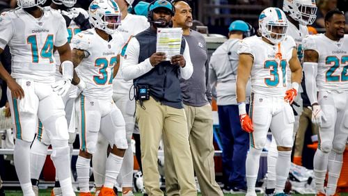 FILE - Miami Dolphins head coach Brian Flores, center, reacts to a call during an NFL football game against the New Orleans Saints, Monday, Dec. 27, 2021, in New Orleans. (AP Photo/Tyler Kaufman, File)