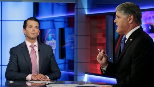 Donald Trump Jr., left, is interviewed by host Sean Hannity on his Fox News Channel television program, in New York Tuesday, July 11, 2017. Donald Trump Jr. eagerly accepted help from what was described to him as a Russian government effort to aid his father's campaign with damaging information about Hillary Clinton, according to emails he released publicly on Tuesday. (AP Photo/Richard Drew)