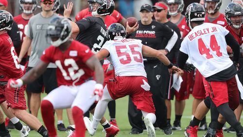 Falcons head coach Dan Quinn (background) knows he needs to get more from the pass rush this season, including Vic Beasley Jr. (right). (Curtis Compton /ccompton@ajc.com)