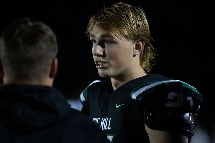 Collins Hill quarterback Sam Horn (21) talks with a coach during a GHSA high school football game between the Collins Hill Eagles and the Grayson Rams at Collins Hill High in Suwanee, GA., on Friday, December 3, 2021. (Photo/ Jenn Finch)