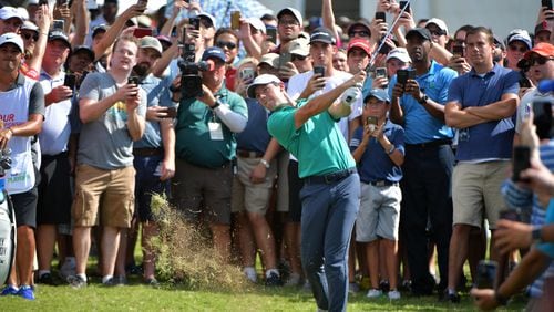 Fans get an up close and personal view of Rory McIlroy during the 2018 Tour Championship.  HYOSUB SHIN / HSHIN@AJC.COM
