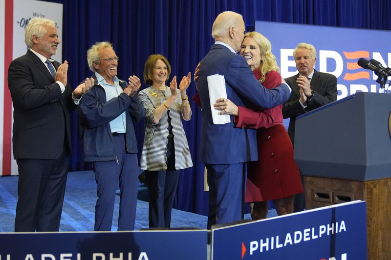 Kerry Kennedy, second right, hugs President Joe Biden at a campaign event, Thursday, April 18, 2024, in Philadelphia. Pictured from left are members of the Kennedy family Maxwell Kennedy Sr., Joe Kennedy III, Kathleen Kennedy Townsend and Christopher Kennedy. (AP Photo/Alex Brandon)
