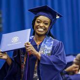 Student Angela Kimbrough reacts after she received her diploma during the Clayton State University Spring 2023 Commencement at the Athletics Center, Friday, May 5, 2023, in Morrow, Ga. (Jason Getz / Jason.Getz@ajc.com)