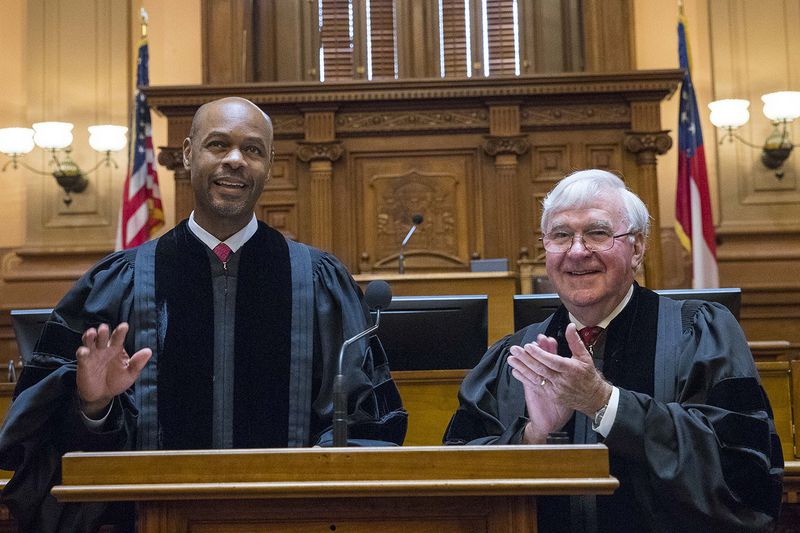 Newly sworn in Georgia Supreme Court Chief Justice Harold D. Melton (left) is applauded by former Chief Justice Harris Hines, who died Sunday in a car accident, during the official oath taking ceremony at the State Capitol in September. On Monday, Melton called Hines “a mentor and one of my dearest friends.” (ALYSSA POINTER/ALYSSA.POINTER@AJC.COM)