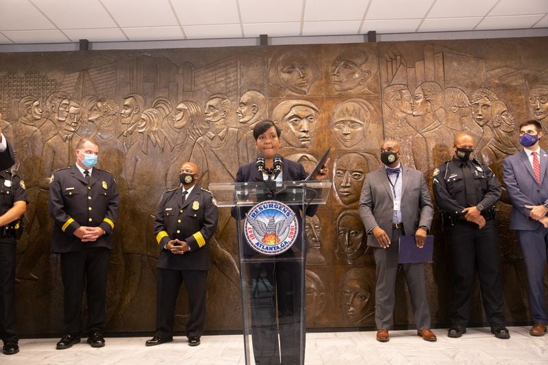 Atlanta Mayor Keisha Lance Bottoms leads a press conference on Aug. 3, 2021, at City Hall to address rising crime, a murder in Piedmont Park, and COVID-19 delta variant concerns. Behind the mayor to her immediate left is Atlanta Police Chief Rodney Bryant. (Jenni Girtman for The Atlanta Journal-Constitution)