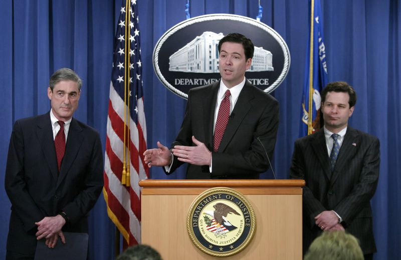 In this photo from Thursday, Feb. 19, 2004, FBI Director Robert Mueller, left, Deputy Attorney General James B. Comey, head of the Justice Department's corporate fraud task force, and Assistant Attorney General Christopher Wray of the Justice Department Criminal Division, right, announce charges against Enron chief executive Jeffrey Skilling, in Washington. Today, 14 years later in April 2018, Christopher Wray is President Donald Trump's FBI director, taking over after Trump fired James B. Comey May 9, 2017, who had served as FBI director since 2013. On May 17, 2017. Robert Mueller was appointed as a special counsel to investigate Russian meddling in the U.S. election and whether there were any links or coordination between Russian government and individuals associated with the campaign of President Donald Trump. (AP Photo/J. Scott Applewhite)