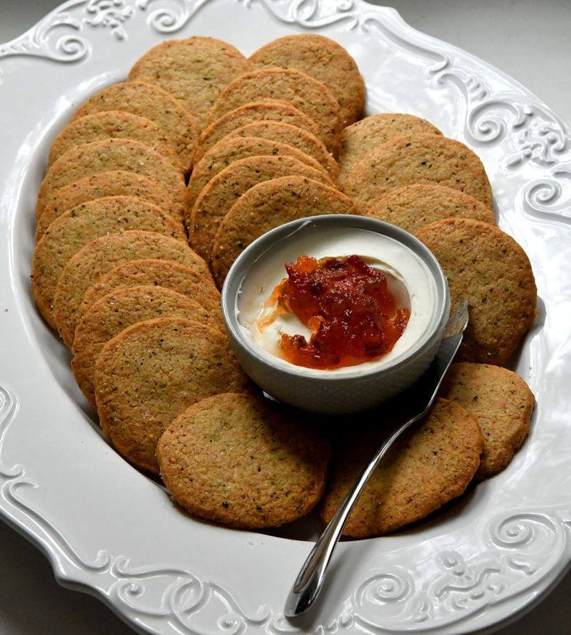 Cheddar Black Pepper Sables are served here with cream cheese and pepper jelly. (Styling by Ashley Thomas and Morgan Perkins / Chris Hunt for the AJC)