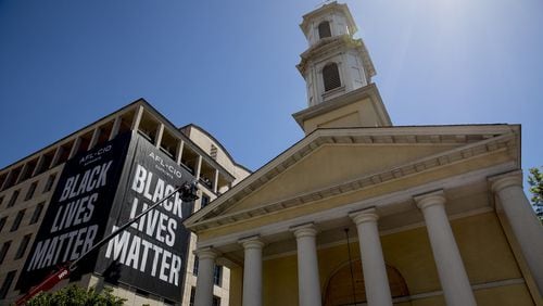 St. John’s Episcopal Church is visible as a large banner that reads Black Lives Matter is hung from the AFL-CIO building on part of 16th Street renamed Black Lives Matter Plaza, a site of protests, Friday, June 12, 2020, near the White House in Washington. The protests began over the death of George Floyd, a black man who was in police custody in Minneapolis. Floyd died after being restrained by Minneapolis police officers. (AP Photo/Andrew Harnik)