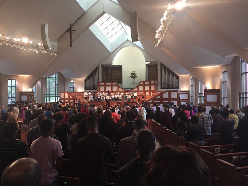 At Ebenezer Baptist Church in Atlanta, the congregation where Martin Luther King, Jr. sometimes preached decades ago, some attendees were glad to hear Rev. Shanan Jones condemn both the Charlottesville violence and what he called  white supremacists  in the White House. Jones made the remarks in a prayer at the late morning service shown here on August 13, 2017.