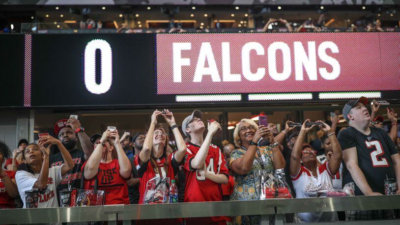 Fans look up as the roof opens during a ceremony before the Falcons open practice Sunday, July 29, 2018, at Mercedes-Benz Stadium in Atlanta.