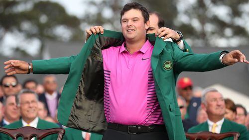 Patrick Reed tries on his new everyday jacket after winning the Masters. (Jason Getz/Atlanta Journal-Constitution/TNS)