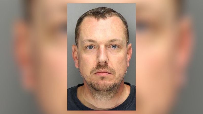 Daniel Ryan Caudell, 45, was arrested Friday after he was seen with a gun, knife and alcohol on the Sprayberry High School campus, according to police.