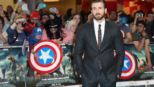 Chris Evans poses for photographers as he arrives for the UK premiere of the movie Captain America: The Winter Soldier at the Vue Westfield on Thursday, March 20, 2014 in London. (Photo by Joel Ryan/Invision/AP Images)
