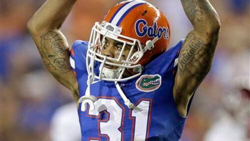 FILE - In this Sept. 5, 2015, file photo, Florida defensive back Jalen Tabor raises his arms to fans as they cheer during the first half of an NCAA college football game against New Mexico State in Gainesville, Fla. Florida coach Jim McElwain has suspended Tabor and tight end C'yontai Lewis on Wednesday, Aug. 17, 2016, saying neither will play in the team's season opener against UMass. (AP Photo/John Raoux, File)
