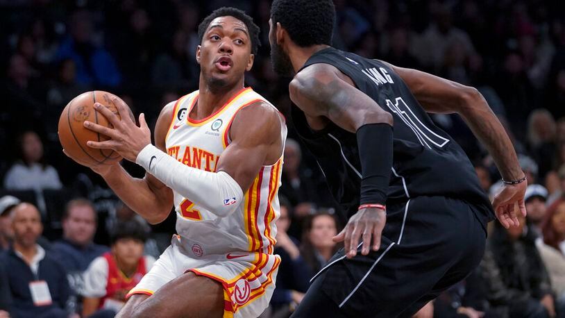 Atlanta Hawks guard Trent Forrest (2) drives against Brooklyn Nets guard Kyrie Irving during the first half of an NBA basketball game Friday, Dec. 9, 2022, in New York. (AP Photo/Mary Altaffer)