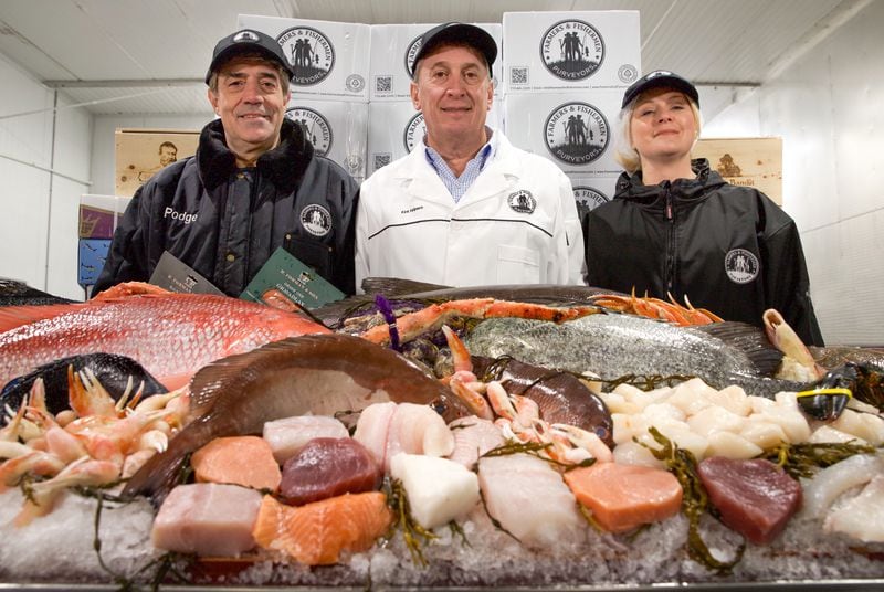 (left to right), Fresh fish buyer Podge Sgambato, owner Kirk Halpern, and oyster buyer Melissa Fedorko show off the company’s wide range of seafood. 
Courtesy of Farmers & Fishermen Purveyors