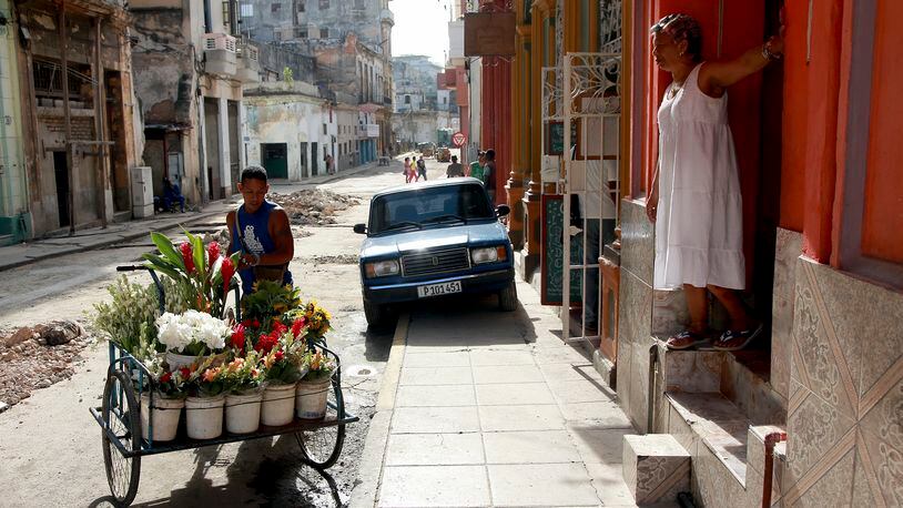 A flower salesman pushes his cart down a street in Havana. While the Internet is essential for today's business, Cuba still has some of the worst Internet access in the world.