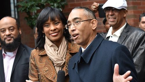 DeKalb County CEO Burrell Ellis speaks to members of the media alongside his wife Philippa outside the county government building on Wednesday. Ellis retook office for the remainder of his dwindling term that expires at the end of the year. HYOSUB SHIN / HSHIN@AJC.COM