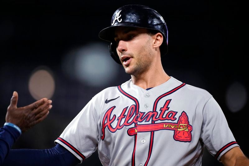 Atlanta Braves' Matt Olson is congratulated after his two-run single off Colorado Rockies relief pitcher Lucas Gilbreath during the 10th inning of a baseball game Friday, June 3, 2022, in Denver. (AP Photo/David Zalubowski)