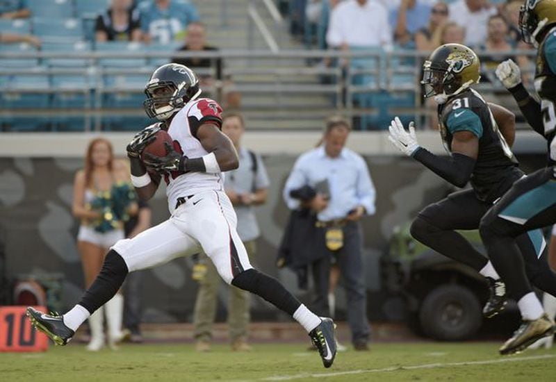 Atlanta Falcons wide receiver Freddie Martino (18) outruns Jacksonville Jaguars cornerback Jeremy Harris (31) and other defenders enroute to a 67-yard touchdown during the first half of an NFL preseason football game in Jacksonville, Fla., Thursday, Aug. 28, 2014. (AP Photo/Phelan M. Ebenhack)