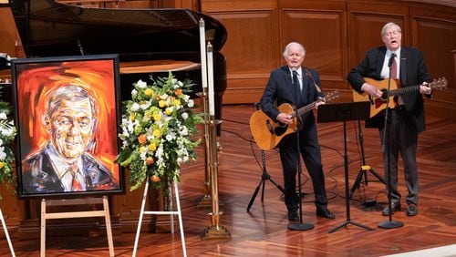 Musicians Banks and Shane perform “God Bless America” beside a portrait of U.S. Sen. Johnny Isakson during his funeral Thursday at Peachtree Road United Methodist Church. Ben Gray for the Atlanta Journal-Constitution