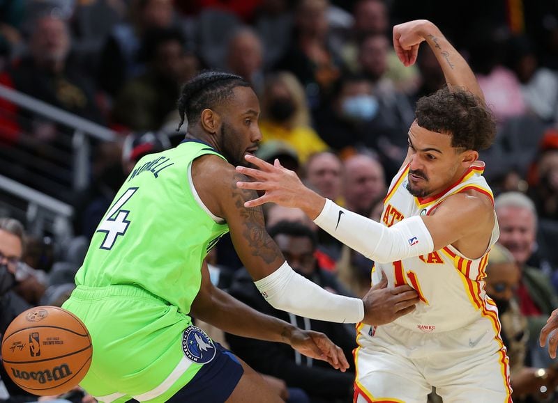 The Atlanta Hawks' Trae Young (11) dribbles through the legs of the Minnesota Timberwolves' Jaylen Nowell (4) on the way to scoring a basket during the second half at State Farm Arena on Wednesday, Jan. 19, 2022, in Atlanta. (Kevin C. Cox/Getty Images/TNS)