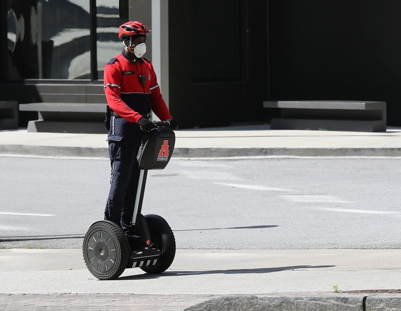 April 9, 2020 Atlanta: A Atlanta police officer patrols the clean and empty streets of the city on Thursday, April 9, 2020, in Atlanta. For the past year, Atlanta residents and city leaders have complained about scooters lying in sidewalks and roadways leading to increased safety concerns for pedestrians and wheelchair users. Curtis Compton ccompton@ajc.com
