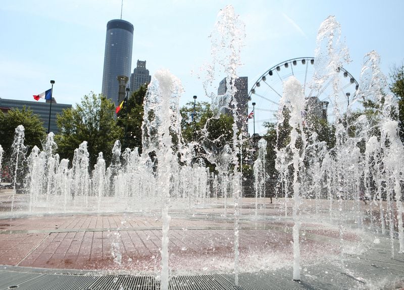 July 20, 2016 Atlanta: The Fountain of Rings plash in front of Atlanta skyscrapers and the SkyView ferris wheel in Centennial Olympic Park on Wednesday, July 20, 2016. This year Atlanta is celebrating the 20th anniversary of the 1996 Olympic Games. EMILY JENKINS/ EJENKINS@AJC.COM