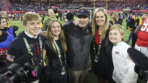 Georgia head coach Kirby Smart and his wife Mary Beth pose for a family photograph after Georgia defeated TCU in the 2023 College Football Playoff National Championship at SoFi Stadium, Monday, Jan. 9, 2023, in Inglewood, Ca. Also pictured are Kirby’s children, twins Weston and Julia, left, and Andrew, right. Georgia won 65-7. (Jason Getz / Jason.Getz@ajc.com)