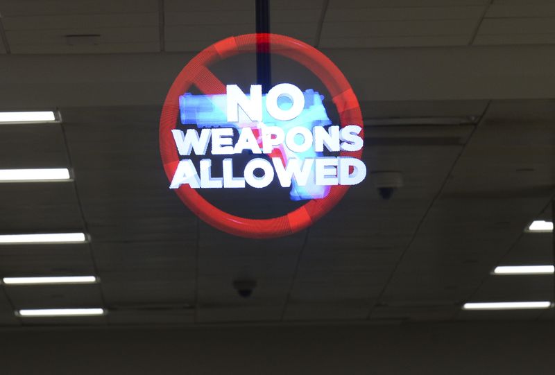 A holographic image advising passengers against bringing weapons into the security checkpoint area is seen Wednesday, April 6, 2022 at Hartsfield-Jackson International Airport. (Daniel Varnado/For the Atlanta Journal-Constitution)