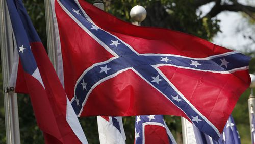 FILE - In this July 19, 2011, file photo, Confederate battle flags fly outside the museum at the Confederate Memorial Park in Mountain Creek, Ala. The Confederate battle flag has been removed from South Carolina's Statehouse grounds, in the wake of the massacre of nine African-Americans, including a state senator, at an historic black church in Charleston in June 2015. (AP Photo/Dave Martin, File)