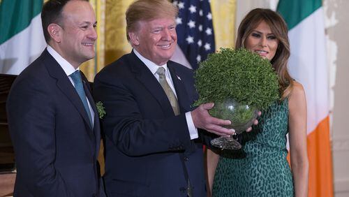 Prime Minister Leo Varadkar of Ireland, President Donald J. Trump, and first lady Melania Trump pose with a bowl of shamrocks presented by Varadkar to Trump last week. Alex Edelman/Getty Images