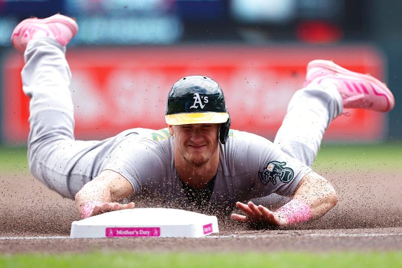 Oakland Athletics' Sean Murphy (12) steals third base on a wild pitch by Minnesota Twins starting pitcher Chris Paddack (20) during the first inning of a baseball game Sunday, May 8, 2022, in Minneapolis. (AP Photo/Stacy Bengs)