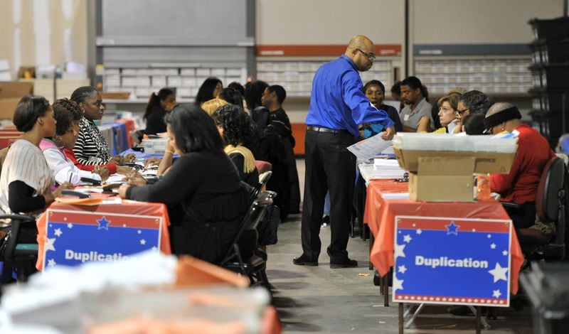 Ralph Jones (standing), registration manager of Fulton County Registration & Elections, supervises as elections workers process provisional ballots in Atlanta on Friday, Nov. 9, 2012.