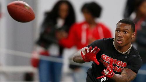 Former UGA wide receiver Mecole Hardman (4) reaches for a pass during Pro Day at the University of Georgia, Wednesday, March 20, 2019, in Athens, Ga. (Joshua L. Jones/Athens Banner-Herald via AP)