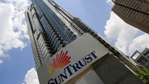 Profits at Georgia’s banks rose almost 5 percent last year despite a late-year dip in income at the state’s biggest bank, SunTrust. (AP Photo/John Bazemore)